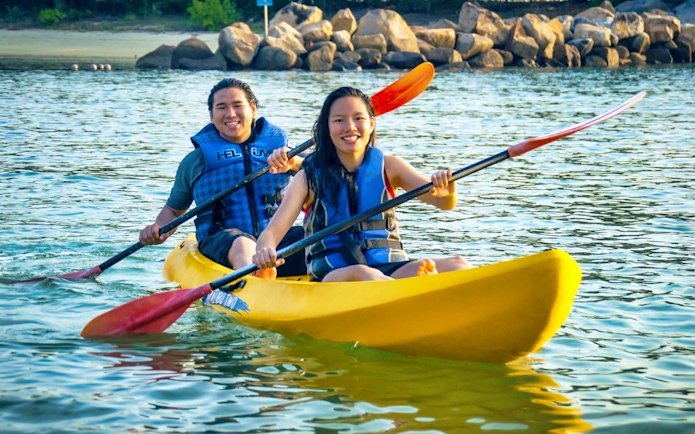 Two people kayaking at Ola Beach Club, Singapore.