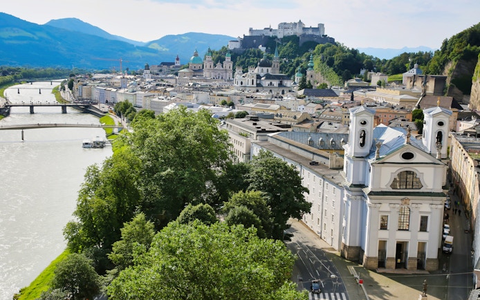 Salzburg cityscape with Hohensalzburg Fortress and Salzach River, view from Original Sound of Music Tour.