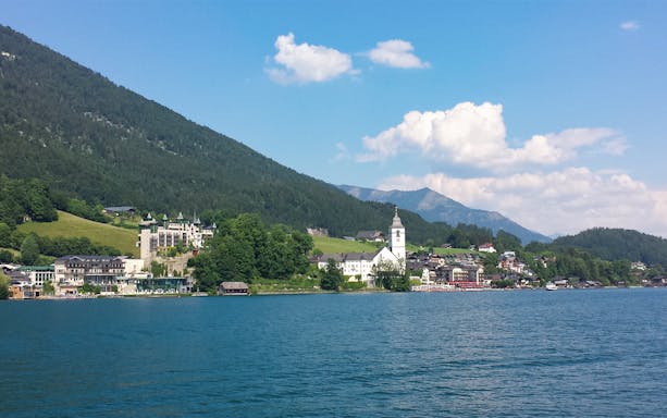 Salzburg lakeside village with church and mountains, part of Sound of Music and Salt Mines tour.