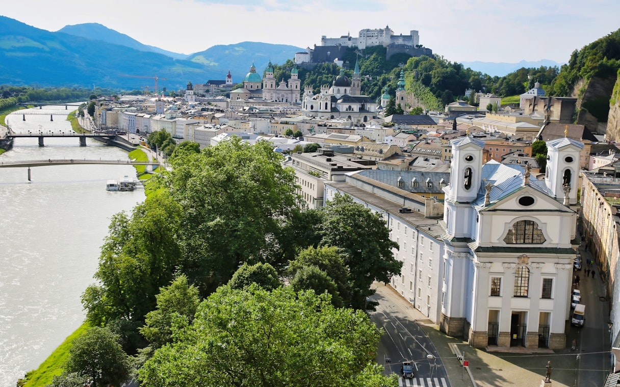 Salzburg cityscape with Hohensalzburg Fortress and Salzach River, Austria.