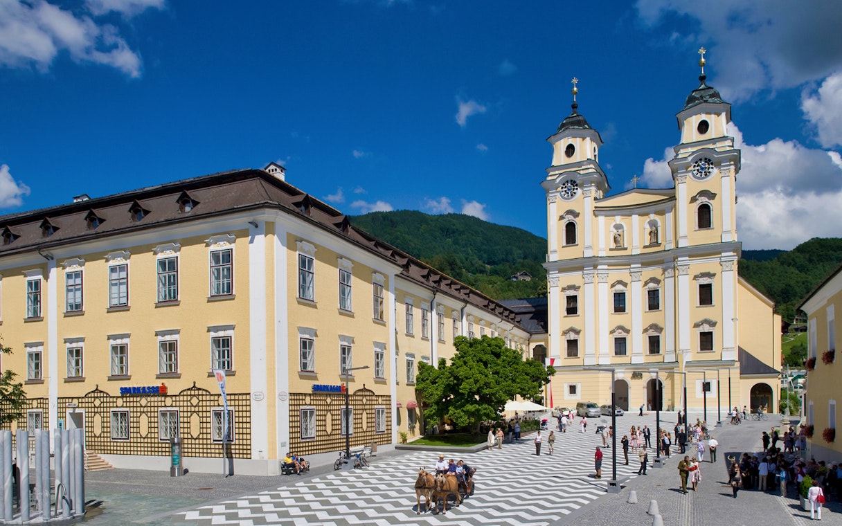 Salzburg's Mondsee Basilica with tourists in the square, part of the Sound of Music tour.