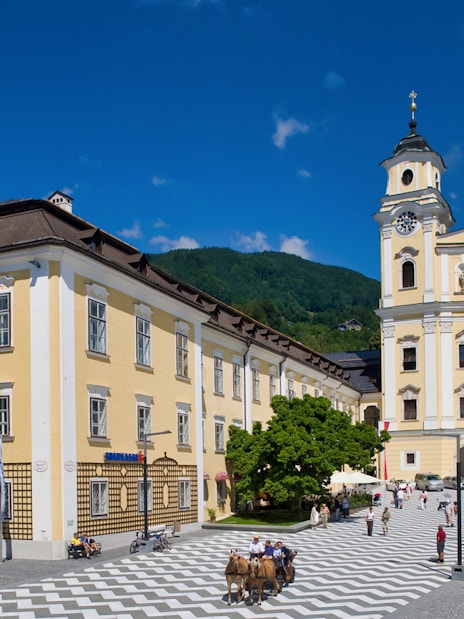 Salzburg's Mondsee Basilica with tourists in the square, part of the Sound of Music tour.