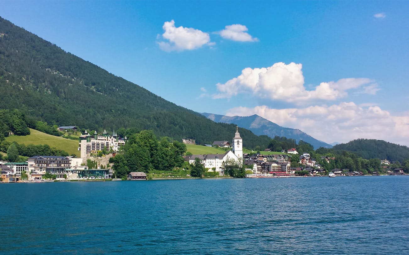 Salzkammergut lake with mountains and village view on tour from Salzburg.
