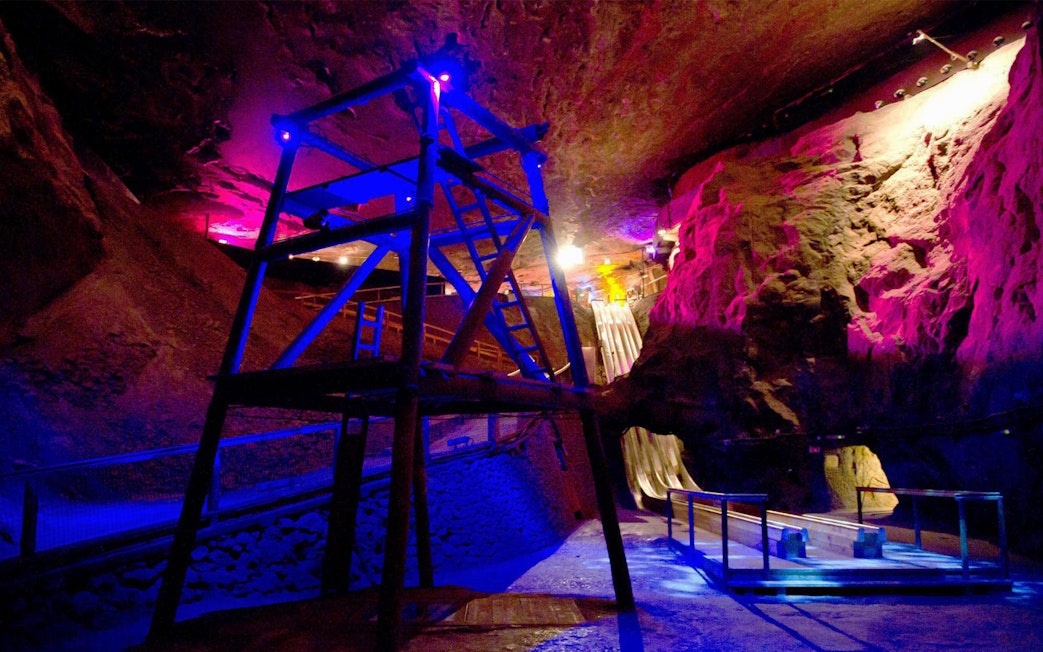 Bavarian salt mine interior with colorful lights and wooden slides, Berchtesgaden tour from Salzburg.
