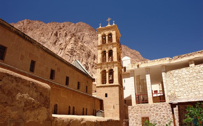 St. Catherine’s Monastery bell tower against Sinai mountains, Sharm-El-Sheikh tour.