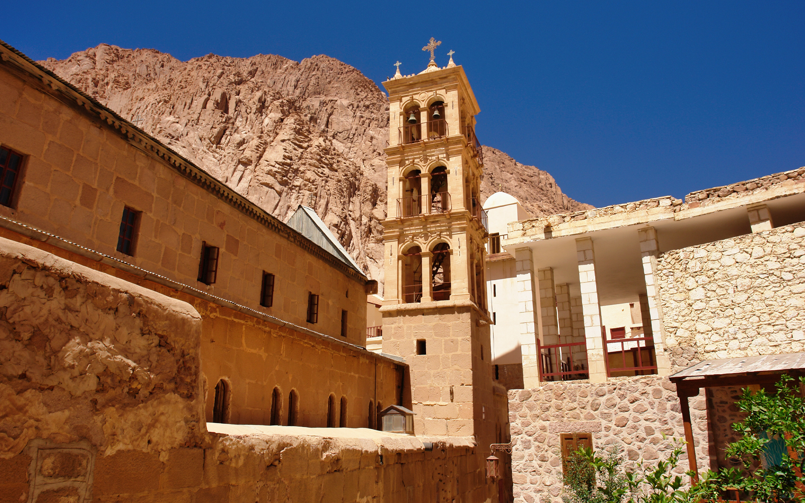 Monastery with bell tower against mountain backdrop in Sharm-El-Sheikh.