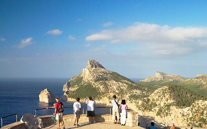 Visitors enjoying the view of Cap Formentor cliffs and sea, Mallorca.
