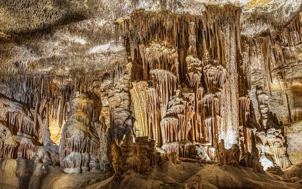 Stalactites and stalagmites in the Caves of Drach, Mallorca, illuminated during a half-day tour.