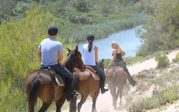 Horseback riders on a scenic trail near the beach in Mallorca.