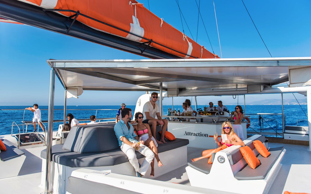 Group relaxing on a catamaran during Palma de Mallorca tour.