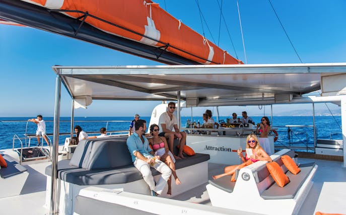 Group relaxing on a catamaran during Palma de Mallorca tour.