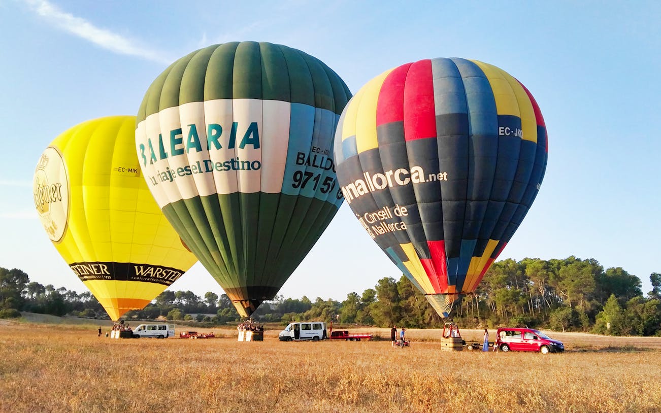 Hot air balloons preparing for flight in a field in Mallorca.