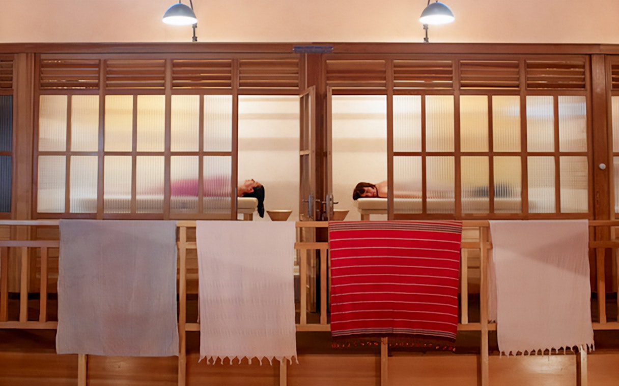 Visitors relaxing in a Turkish hammam in Istanbul, with traditional architecture.