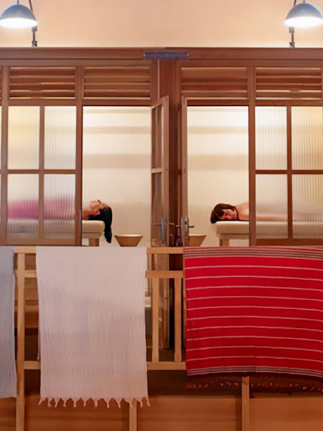 Visitors relaxing in a Turkish hammam in Istanbul, with traditional architecture.