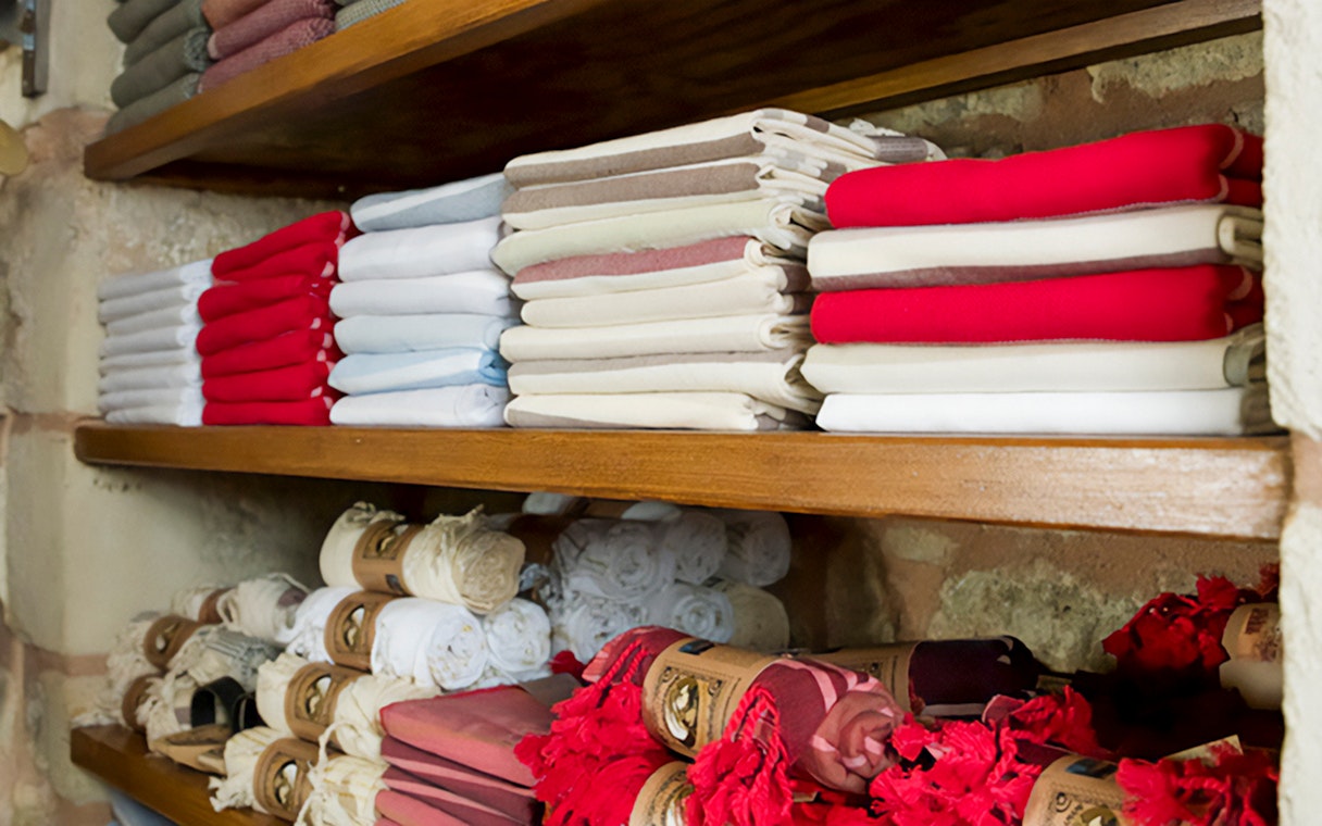 Folded towels on shelves in a Turkish hammam in Istanbul.
