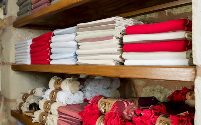 Folded towels on shelves in a Turkish hammam in Istanbul.