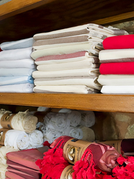 Folded towels on shelves in a Turkish hammam in Istanbul.