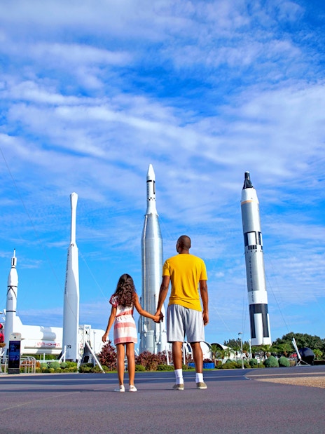 Visitors exploring rocket garden at Kennedy Space Center, Florida.