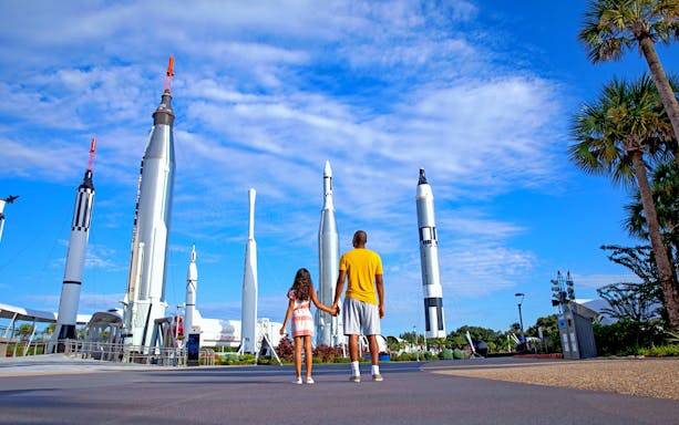 Visitors exploring rocket garden at Kennedy Space Center, Florida.