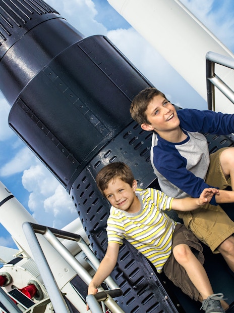 Children exploring a rocket exhibit at Kennedy Space Center, Florida.