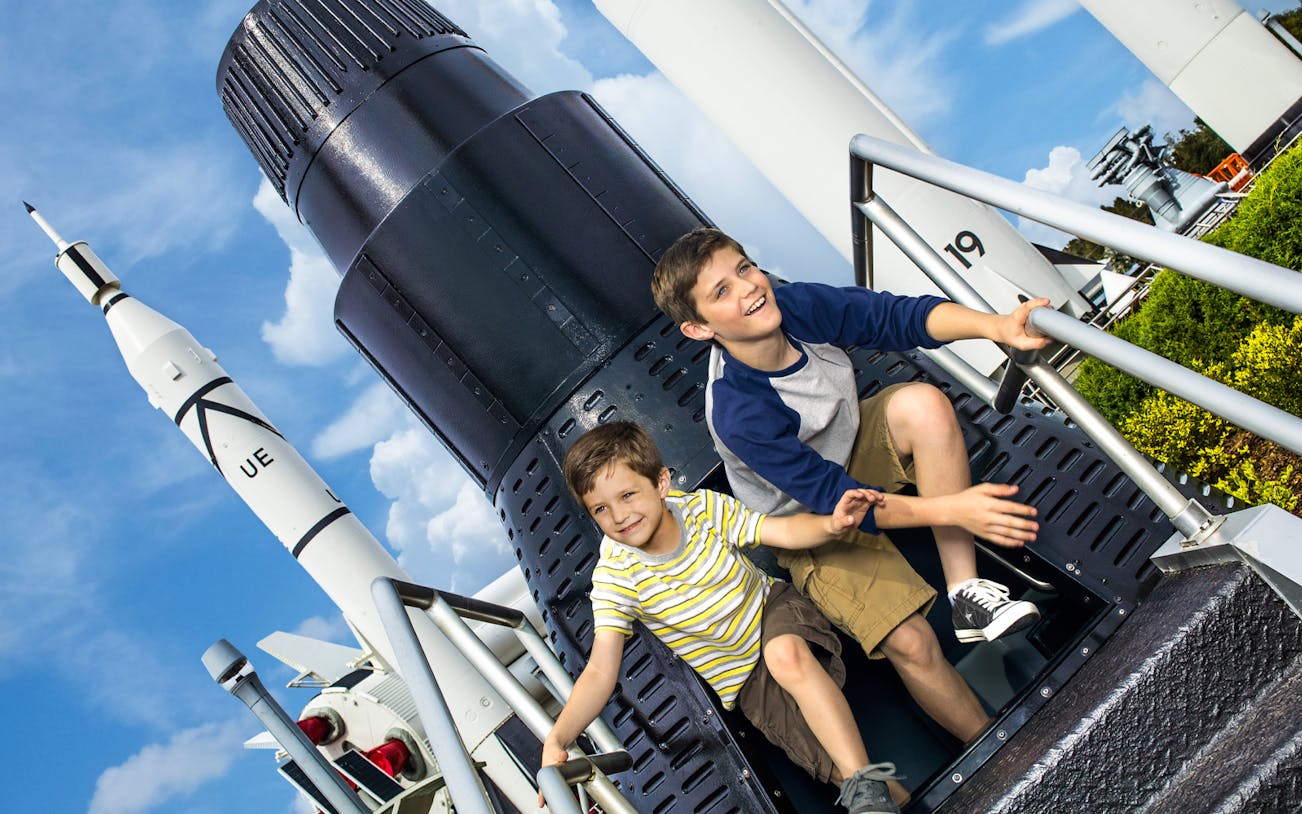 Children exploring a rocket exhibit at Kennedy Space Center, Florida.