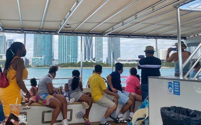 Tourists on a boat viewing Miami skyline during Everglades, Cruise & Double Decker Bus Tour.