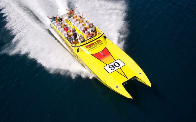 Jetboat speeding through water on Thriller Hurricane 45mins Tour.