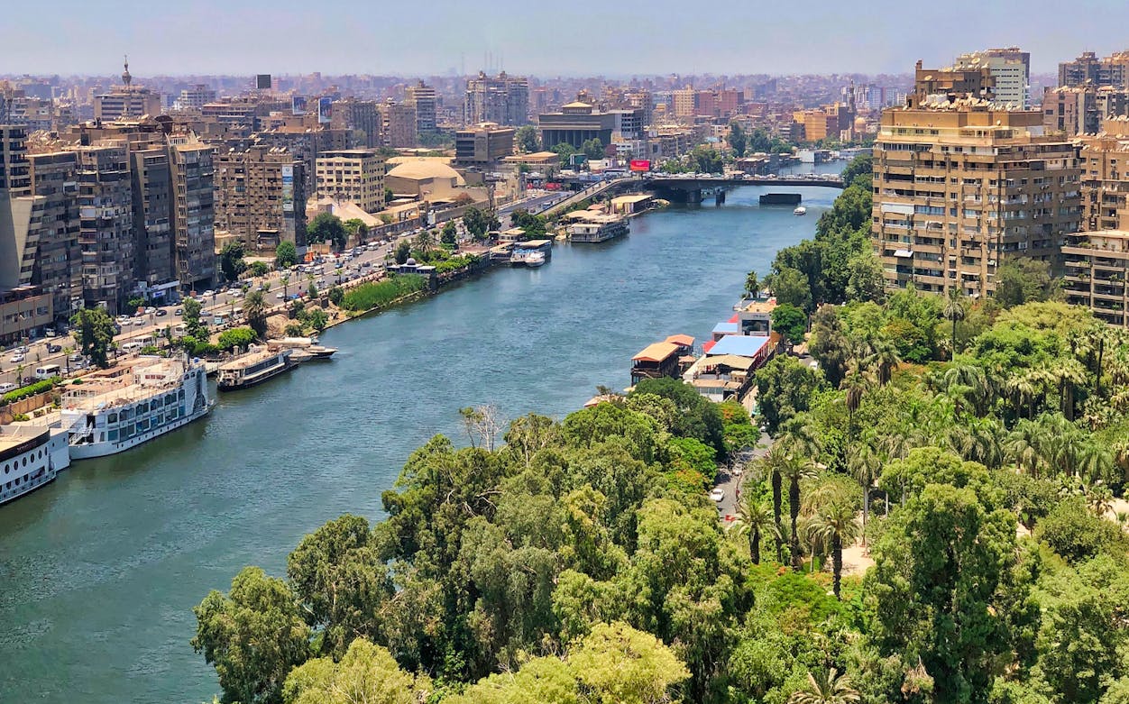 Cairo skyline with Nile River and boats, view from a Cafelluca sailing trip.