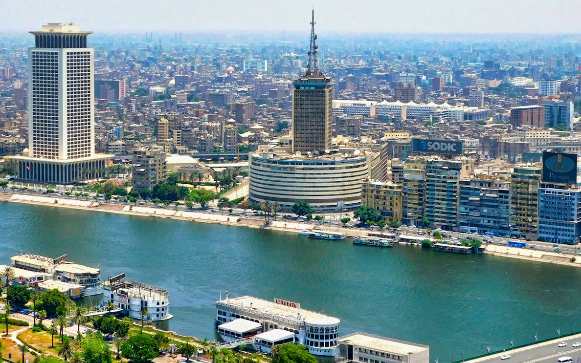 Aerial view of Cairo skyline and Nile River, featuring cruise boats for Nile Crystal Dinner Cruise.