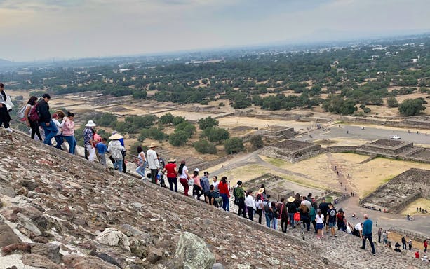 Tourists climbing the Pyramid of the Sun at Teotihuacan, Mexico.