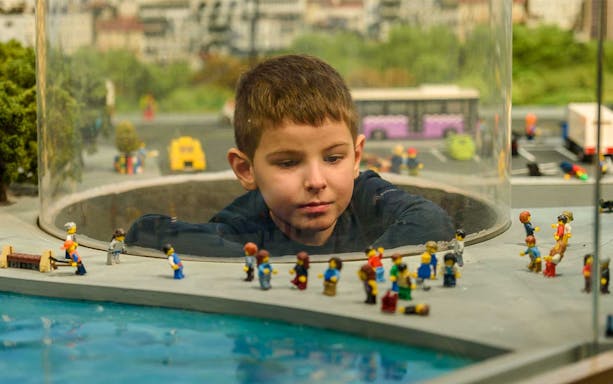Child observing Lego city display at Legoland Discovery Center Istanbul.