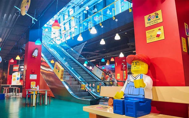 Legoland Discovery Center Istanbul interior with Lego figure and escalator.