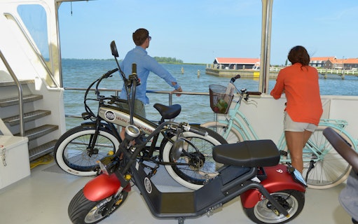 E-scooter and bicycles on a boat during Volendam, Monnickendam, and Marken tour.