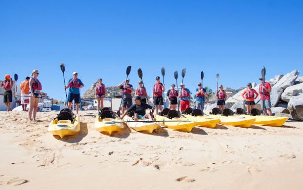 Group preparing for Glass Bottom Kayaks & Snorkeling Tour at the Arch, Cabo San Lucas beach.