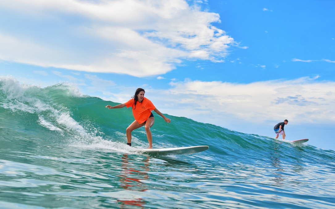 Surfers riding waves during lessons at Costa Azul, Mexico.
