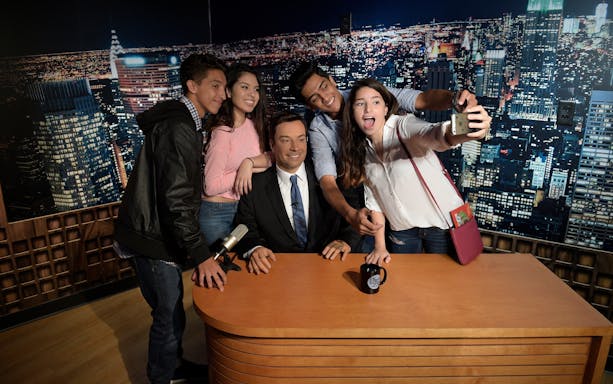 Visitors taking a selfie with a wax figure at Madame Tussauds Orlando.