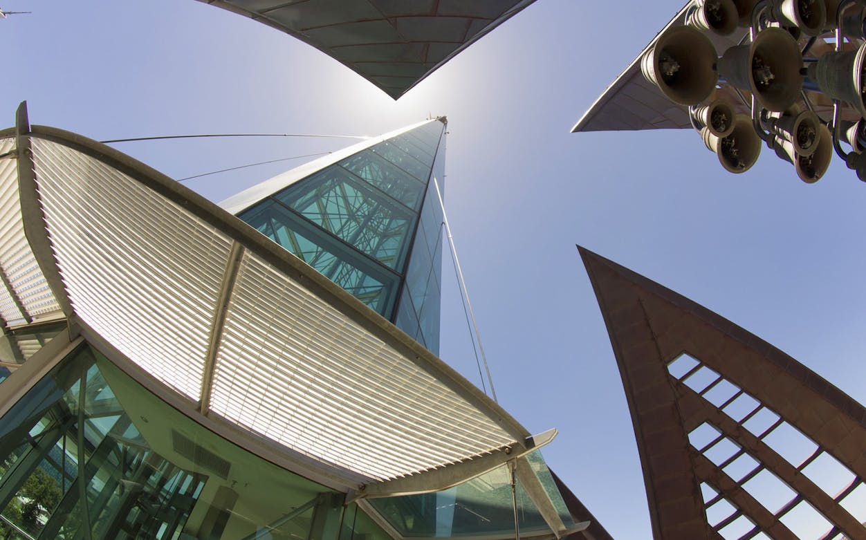 Modern architecture of the Bell Tower in Perth with visible bells and glass panels.