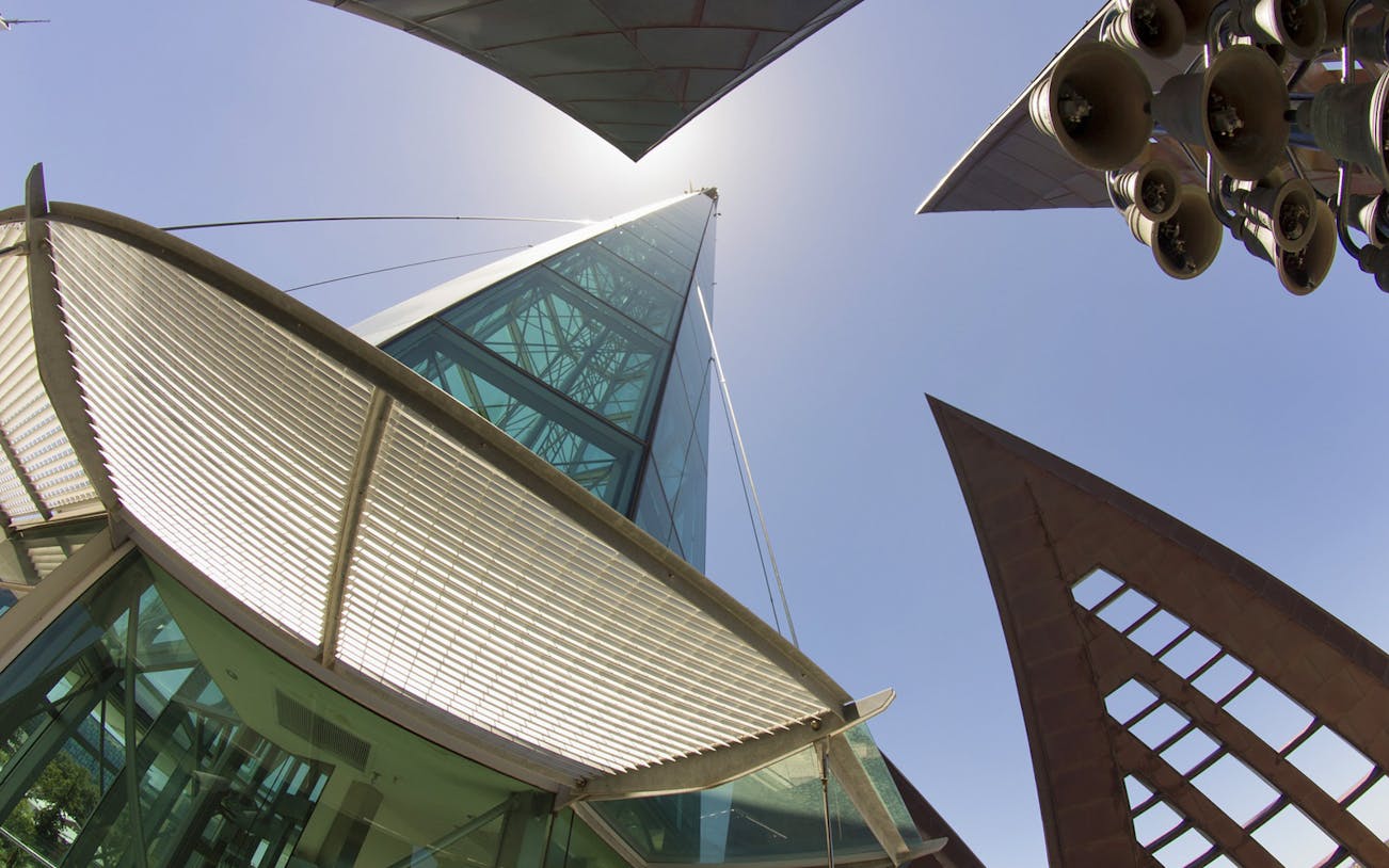 Modern architecture of the Bell Tower in Perth with visible bells and glass panels.