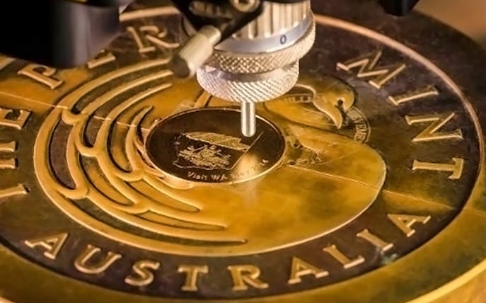 Engraving machine working on a gold coin at The Perth Mint, Australia.