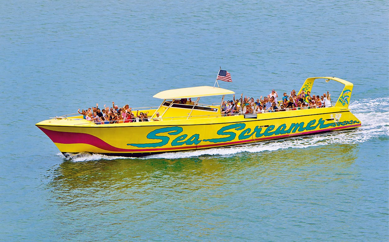 Sea Screamer boat with passengers on Clearwater Beach tour.