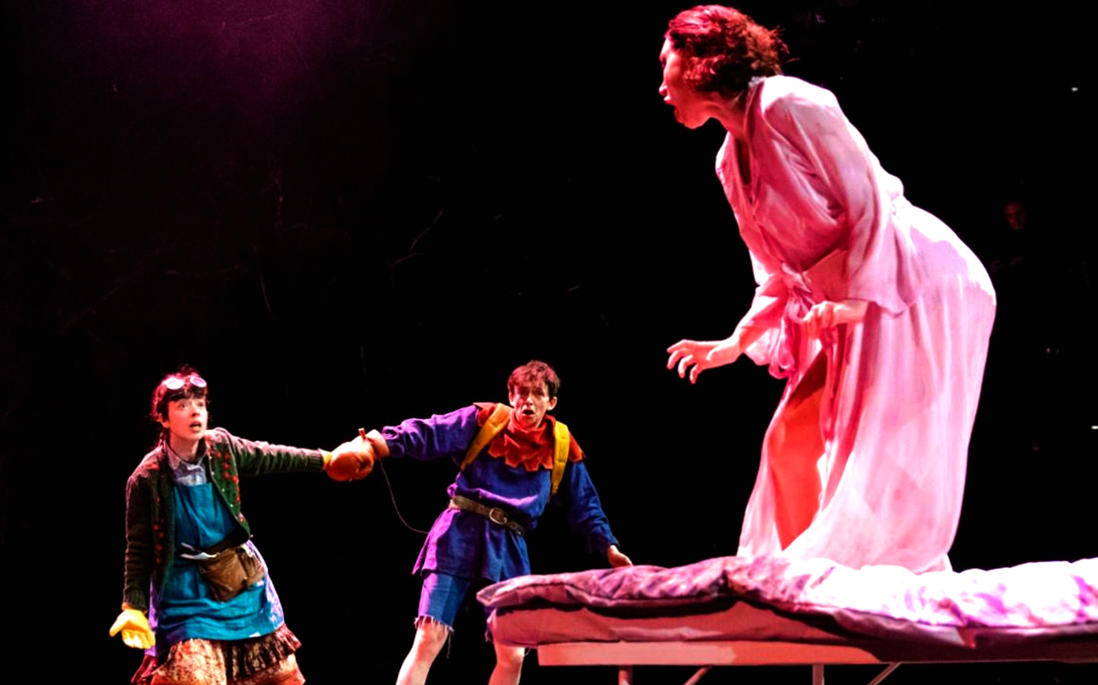 Actors performing a scene from "The Ocean at the End of the Lane" on stage.