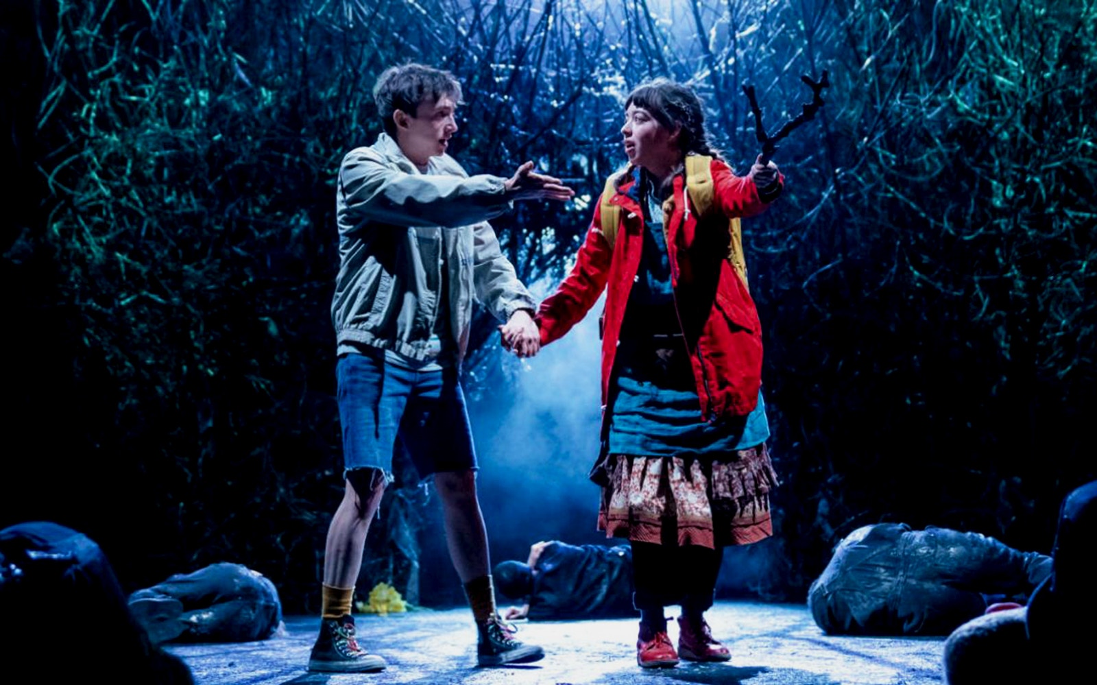 Two actors on stage in a dramatic scene from "The Ocean at the End of the Lane" play.