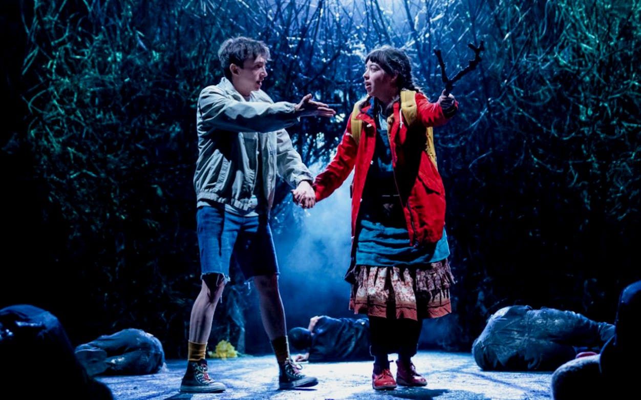 Two actors on stage in a dramatic scene from "The Ocean at the End of the Lane" play.