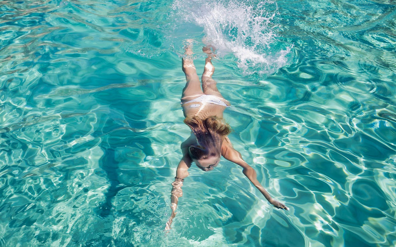 Snorkeler swimming in clear turquoise waters, Mallorca.