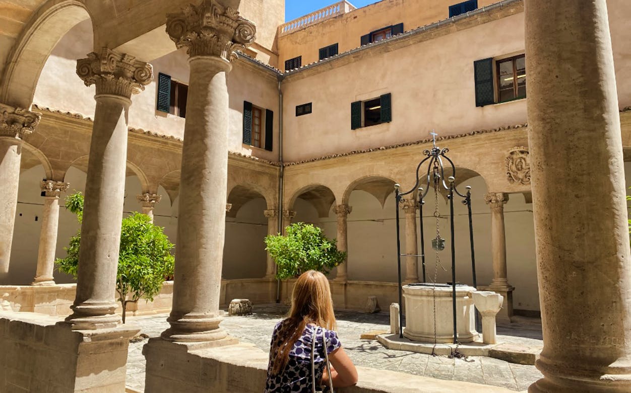 Courtyard with stone columns and a well in Palma, Mallorca.