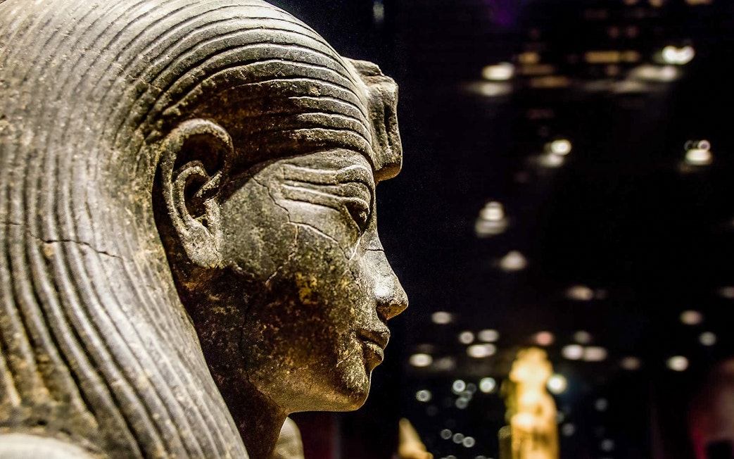 Ancient Egyptian statue in the Egyptian Museum, Cairo, during a guided tour.