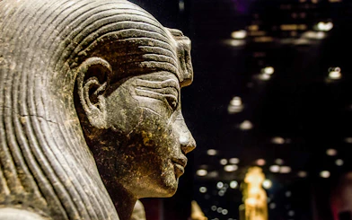 Ancient Egyptian statue in the Egyptian Museum, Cairo, during a guided tour.