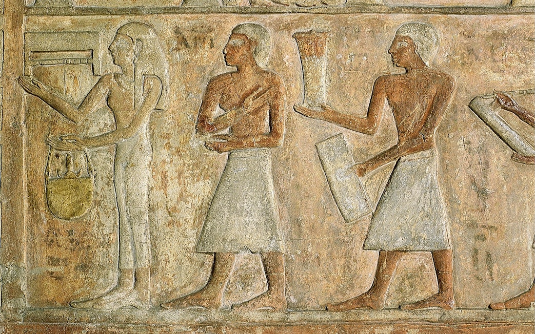 Ancient Egyptian relief depicting figures with offerings at the Egyptian Museum.