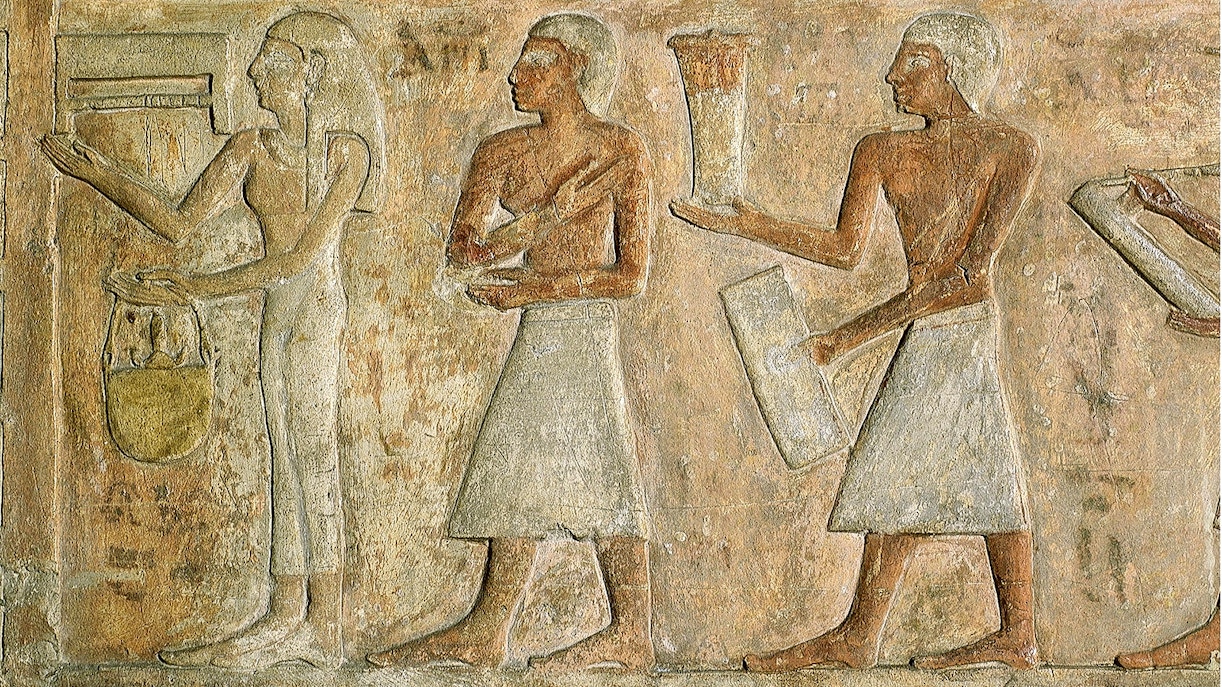 Ancient Egyptian relief depicting figures with offerings at the Egyptian Museum.