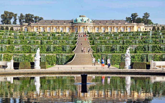 Sanssouci Palace gardens in Potsdam with visitors walking, seen on a guided tour from Berlin.